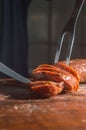 Sliced Ã¢â¬â¹Ã¢â¬â¹smoked calabrese sausage in a wooden table,copy space